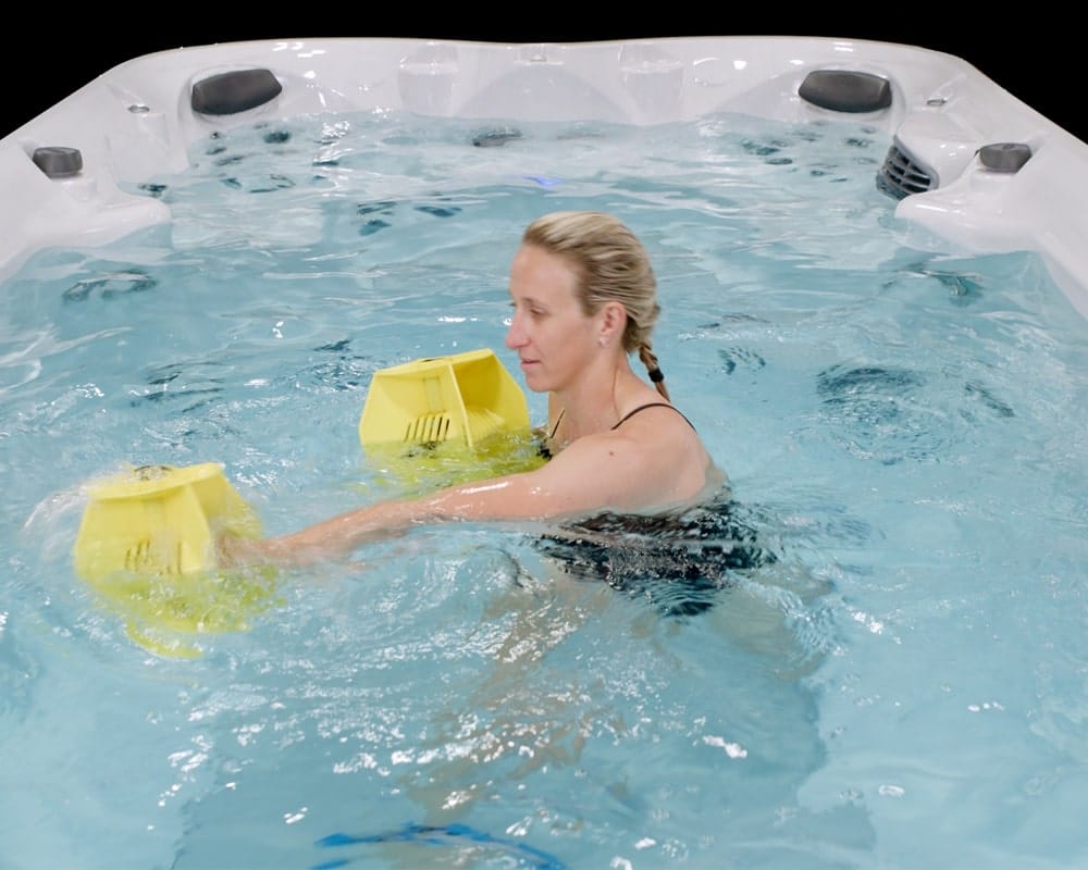 woman doing aqua fitness in swim spa